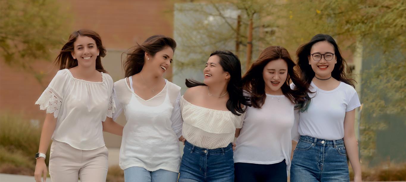five international students laughing